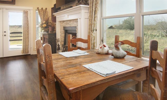 Dining area featuring dark wood-type flooring and a fireplace | Image 11