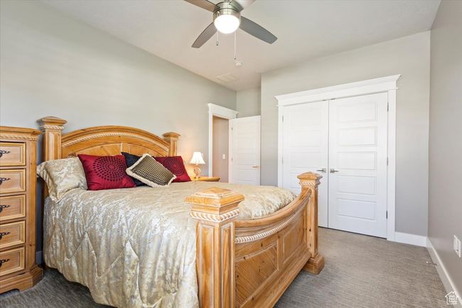 Carpeted bedroom with a closet, baseboards, and ceiling fan | Image 29