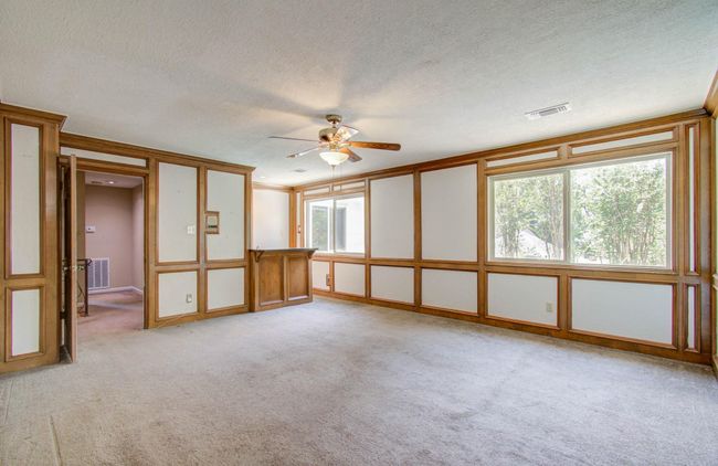 Gameroom up with wet bar and lots of natural lighting. | Image 37