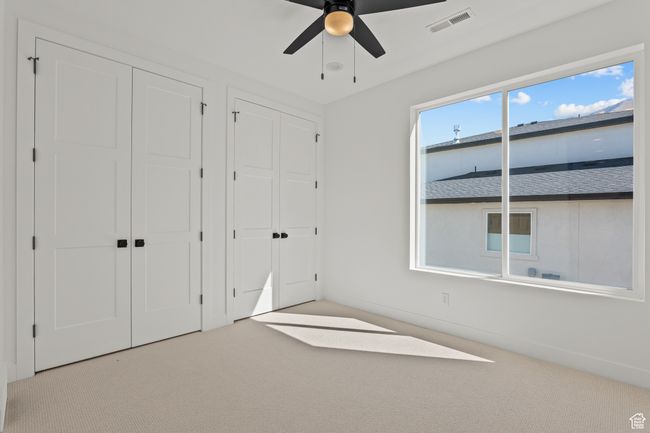 Unfurnished bedroom featuring multiple closets, carpet, and a ceiling fan | Image 38