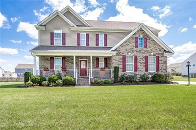 View of front of home with covered porch and a BEAUTIFUL front lawn | Image 1