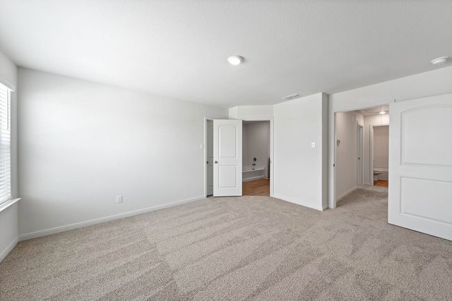 Spare room with light carpet, baseboards, and attic access | Image 5
