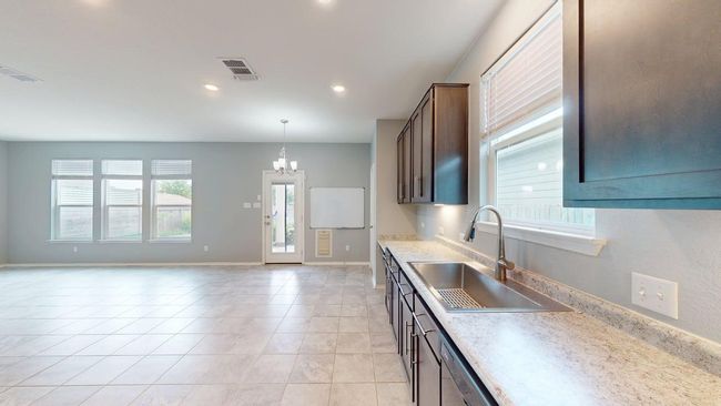 Kitchen featuring visible vents, a sink, light countertops, a chandelier, and light tile patterned flooring | Image 16