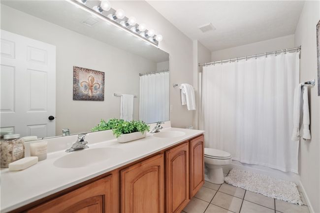 Guest bath with double sinks and ceramic tile. | Image 16