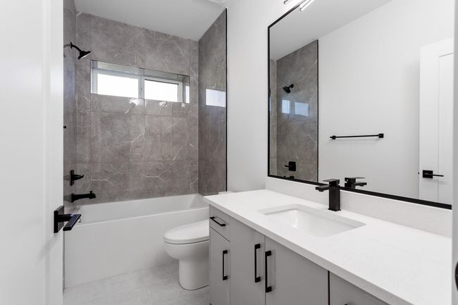 Full bathroom with vanity, toilet, and shower combination | Image 18