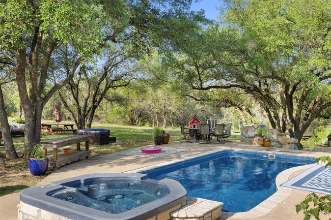 View of pool featuring a patio area and a pool with connected hot tub | Image 12