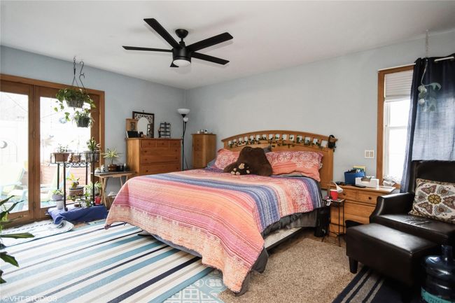 Carpeted bedroom featuring ceiling fan and access to outside | Image 14