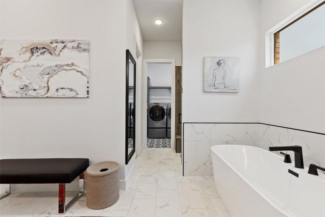 Full bath with a soaking tub, washing machine and dryer, and marble finish floor | Image 20