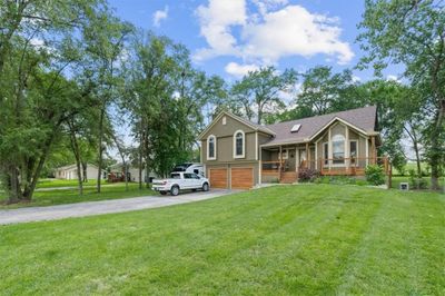 View of front of home featuring a garage, a front yard, and a porch | Image 3