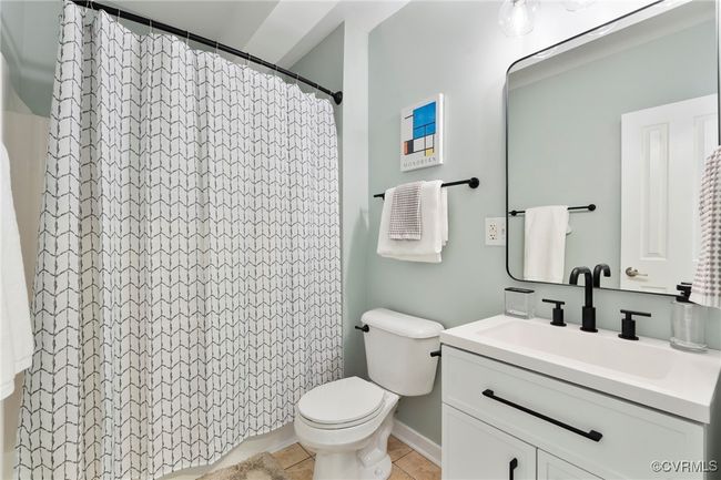 Full bath featuring vanity, tile patterned flooring, and curtained shower | Image 16