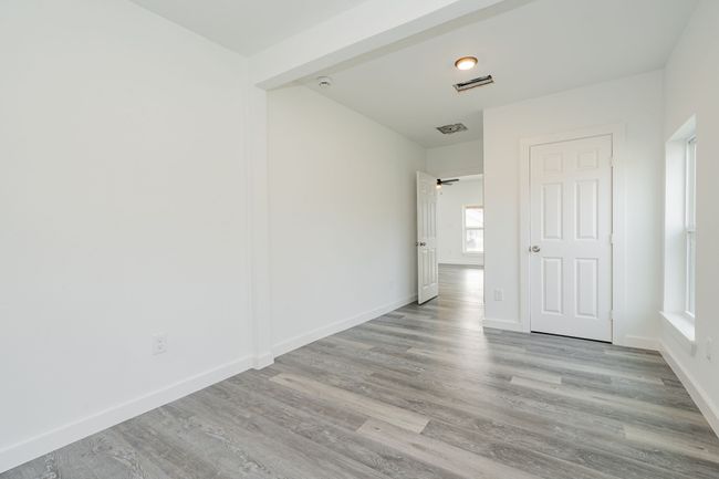 Unfurnished room featuring visible vents, baseboards, and wood finished floors | Image 14