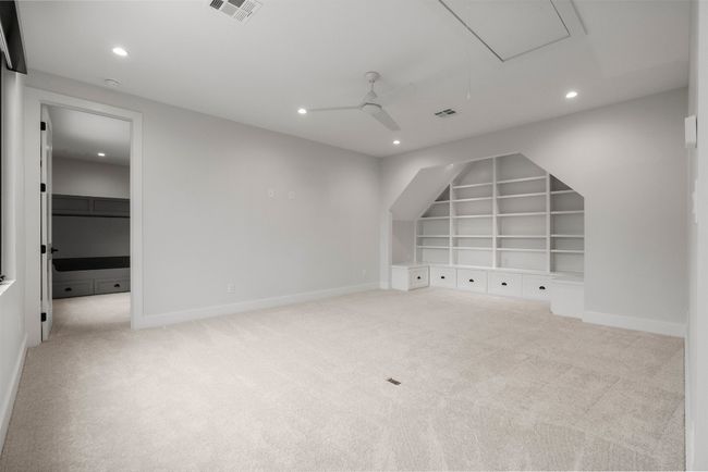 Upstairs, a sprawling game room provides the ultimate recreational space, whether for movie nights, game tournaments, or creative endeavors | Image 23