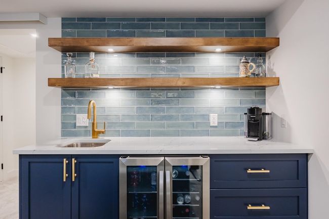 Bar with wet bar, beverage cooler, decorative backsplash, and a sink | Image 29