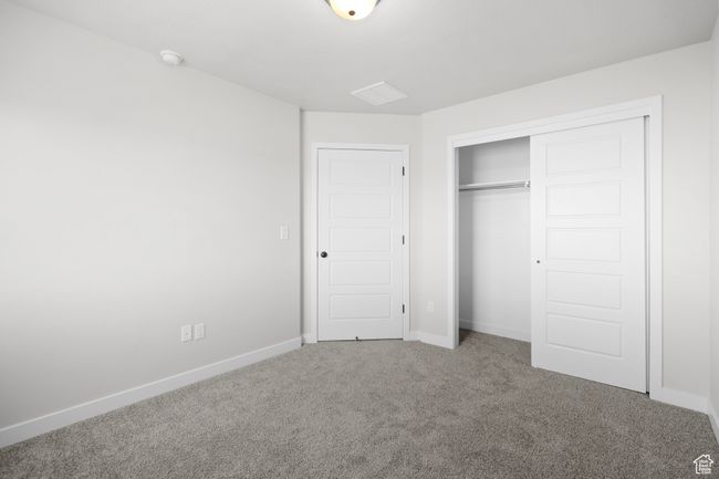 Unfurnished bedroom featuring carpet flooring and a closet | Image 32