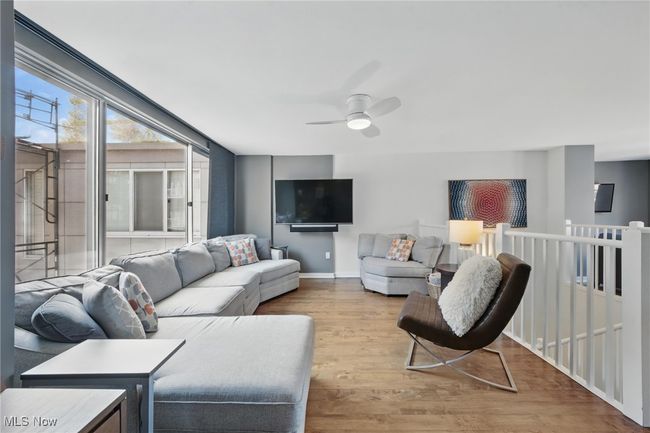 Living area featuring baseboards, a ceiling fan, and wood finished floors | Image 34