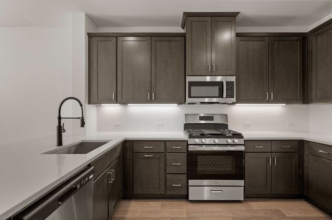 This over the top kitchen offers striking cabinetry, gorgeous countertops and contemporary appliances artfully blended to create a dream kitchen! | Image 9