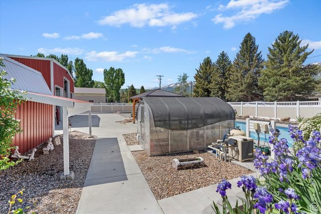Fenced backyard with a patio area | Image 29