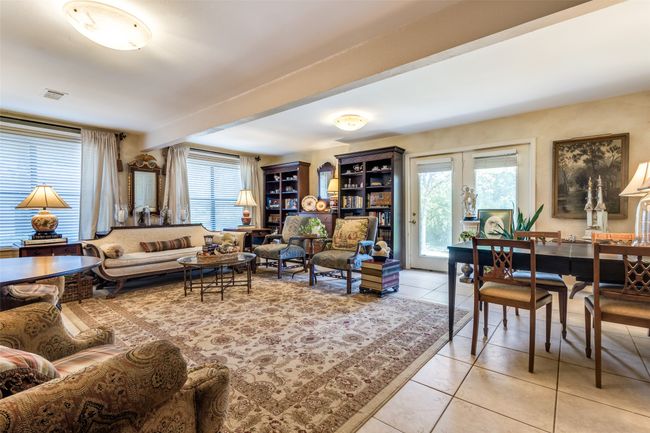 Living room featuring light tile patterned flooring, french doors, and beam ceiling | Image 9