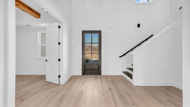 Entrance foyer featuring stairway, visible vents, baseboards, and light wood-style floors | Image 4