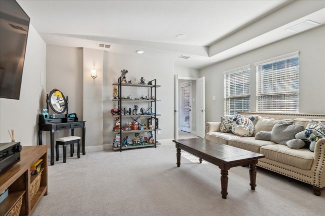 Living area with carpet floors, visible vents, and baseboards | Image 17
