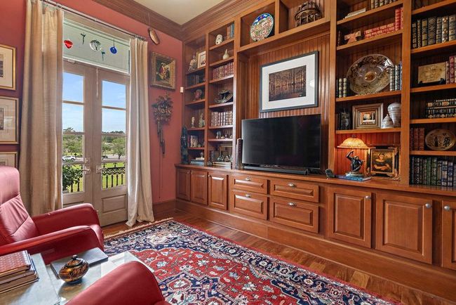 Wall to ceiling sinker Cypress built-ins make this library/office space | Image 26