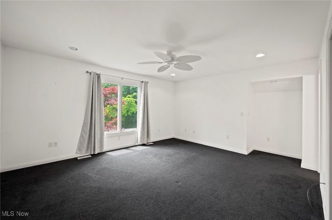 Bedroom featuring ceiling fan, dark colored carpet, and recessed lighting | Image 22