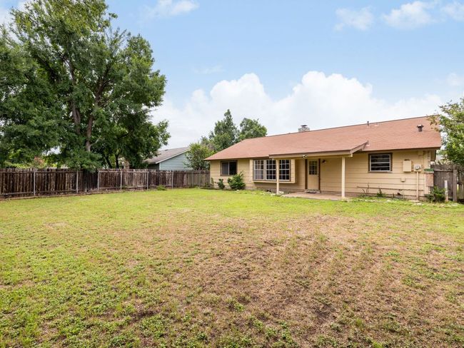 Fenced backyard with a patio area | Image 20