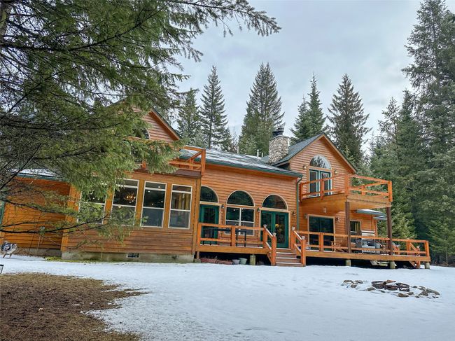 Snow covered property featuring a deck, a balcony, a chimney, and crawl space | Image 23