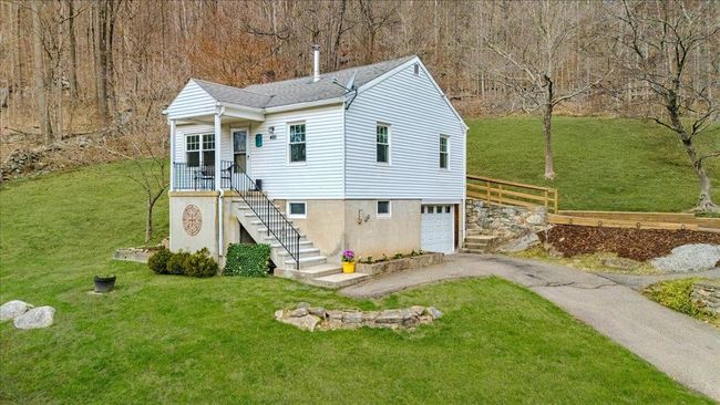 View of front of property featuring driveway, an attached garage, and a front yard | Image 25