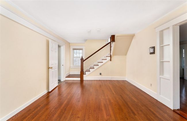 Foyer with baseboards, wood finished floors, and stairs | Image 4