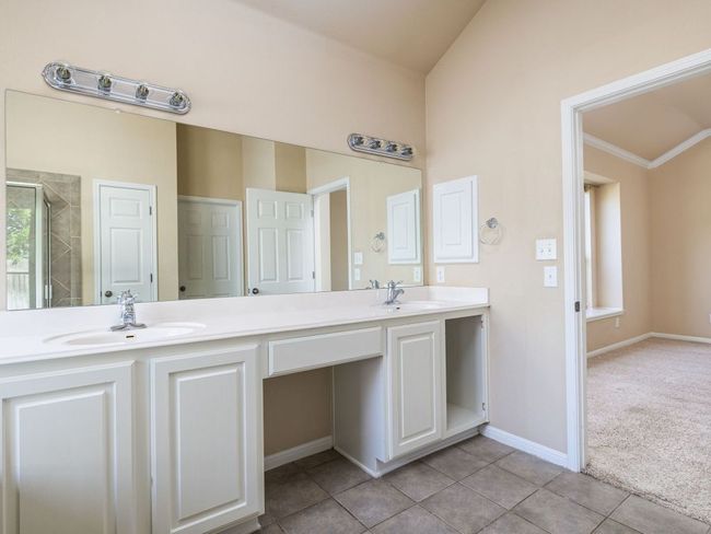 Main bedroom's en-suite bathroom has two vanities, giving ample space for couples to get ready at the same time. | Image 13