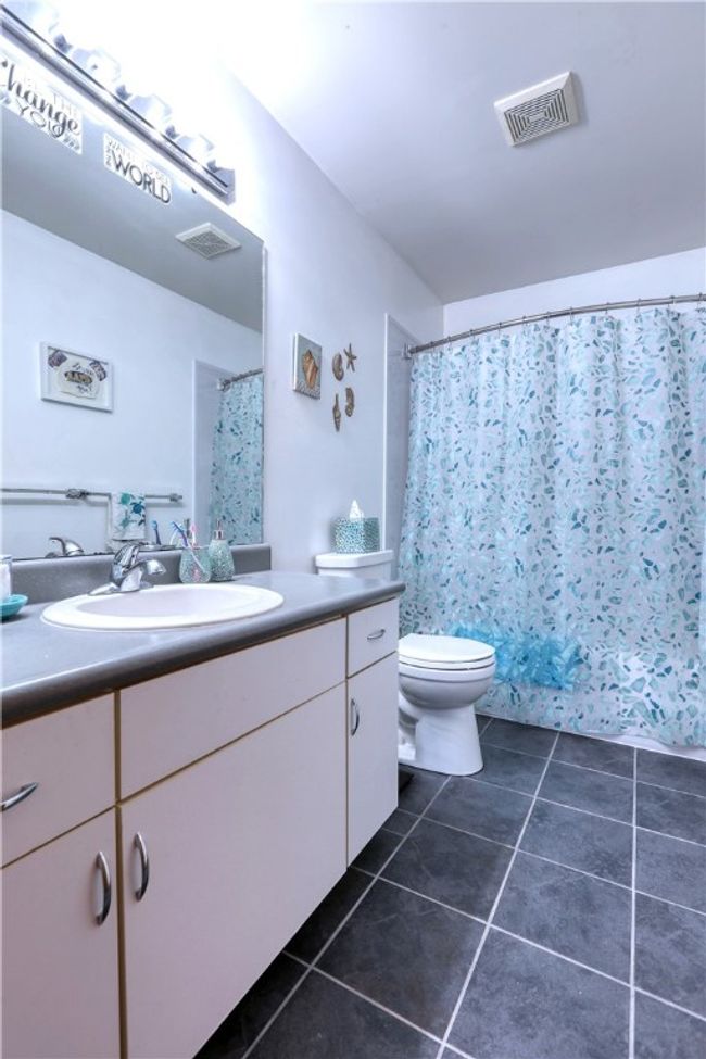 A cheery main bath with Bathfitter tub/shower unit (2018) and waterproof Dupont flooring. | Image 19
