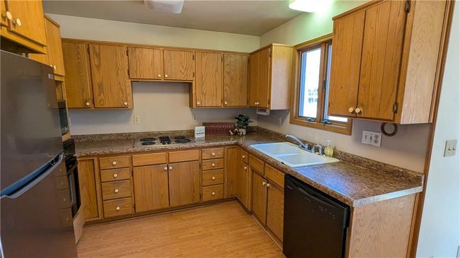 Kitchen featuring dishwasher, white stovetop, sink, stainless steel fridge, and light hardwood / wood-style floors | Image 20