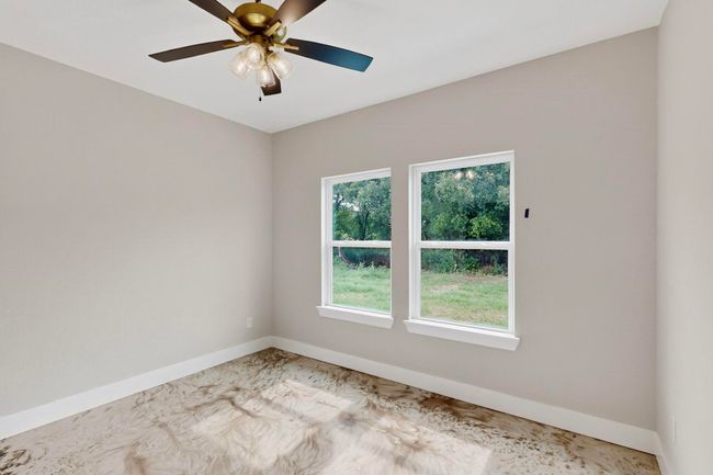 Empty room featuring baseboards and a ceiling fan | Image 32