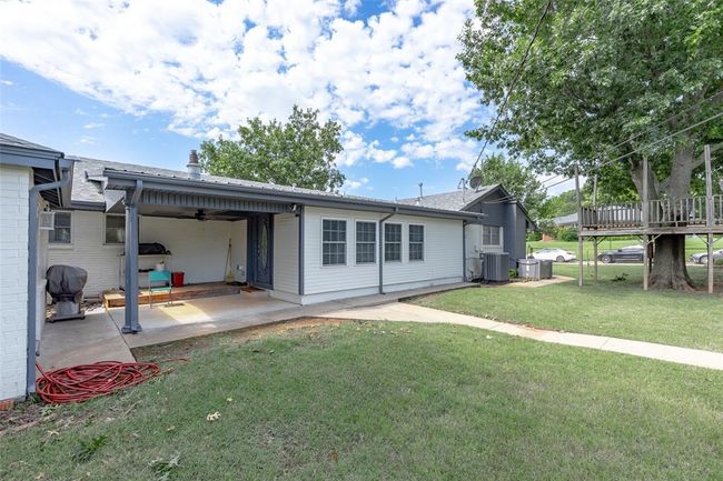 Rear view of property featuring a lawn, ceiling fan, and a patio | Image 36