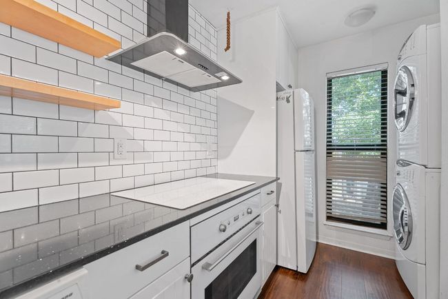 The kitchen also hosts the in unit laundry with stackable washer & dryer hookups. | Image 7