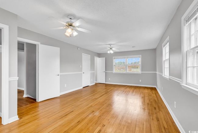 Unfurnished room featuring ceiling fan and light wood-style flooring | Image 18