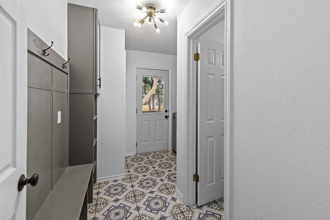 Roomy laundry room with built-in mud and half bath area. | Image 27