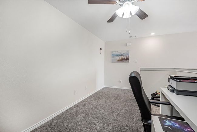 Unfurnished office with ceiling fan, carpet flooring, visible vents, and baseboards | Image 30