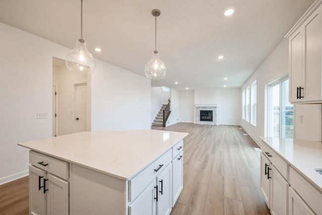 Photo is of the actual home. The kitchen flows into the great room. | Image 4