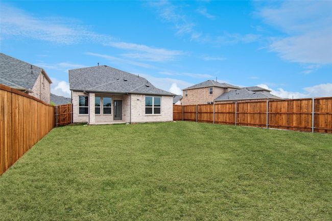 Back of house with a fenced backyard, a patio, roof with shingles, and brick siding | Image 8