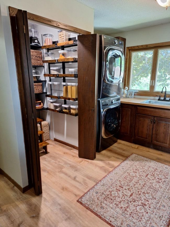 Lower level family room with a cozy wood burning stove and views of Ham Lake | Image 27