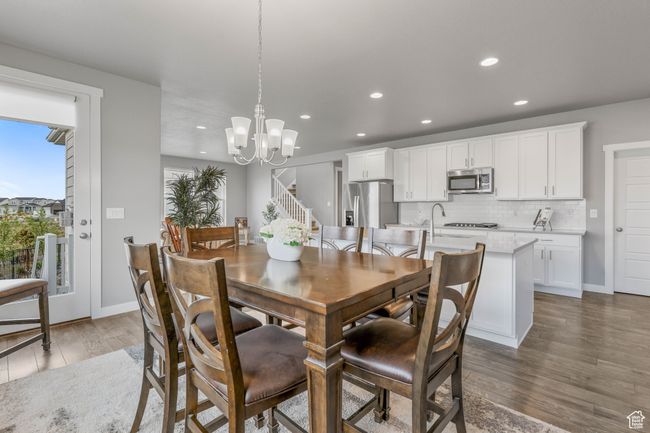 Dining space with recessed lighting, wood finished floors, baseboards, and an inviting chandelier | Image 15