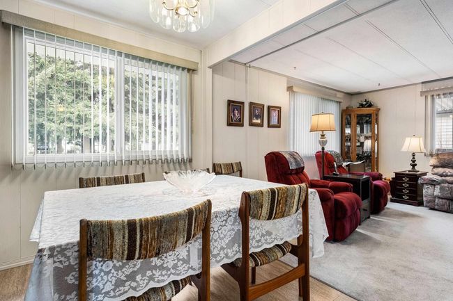 Dining space featuring carpet and a chandelier | Image 11