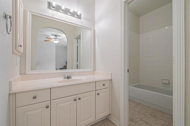 This vanity comes with a large mirror, medicine cabinet and ample storage. There is a private wet-space for these bathrooms to share! | Image 26