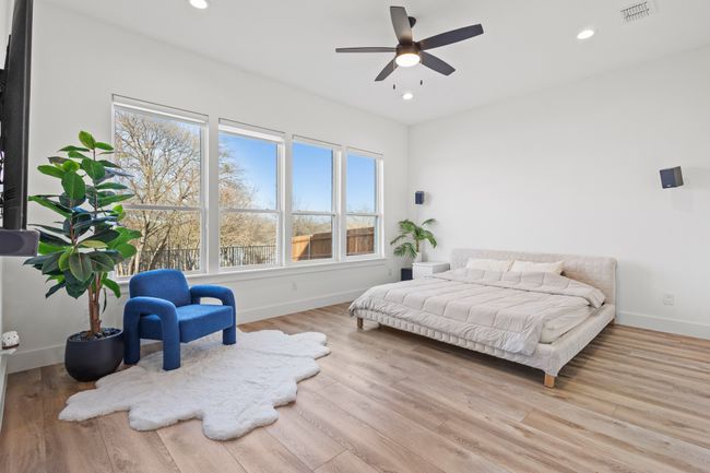 Bedroom with wood finished floors and recessed lighting | Image 19
