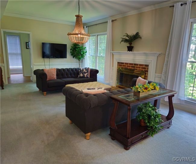 Carpeted living area, brick/wood burning fireplace/mantle | Image 24