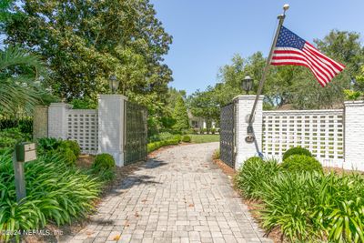 Secured behind a decorative wall and gate you will find this beautiful 1 story | Image 2