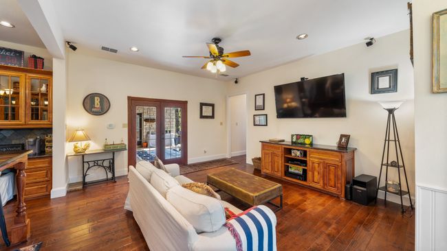 Living room featuring recessed lighting, french doors, dark wood-style flooring, ceiling fan, and visible vents | Image 15