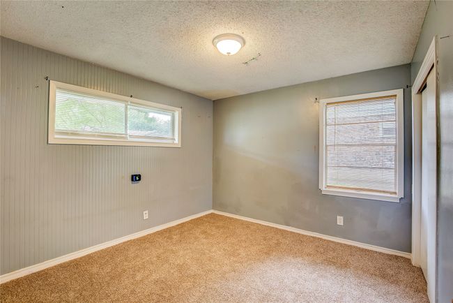 Spare room with carpet floors, baseboards, and a textured ceiling | Image 19
